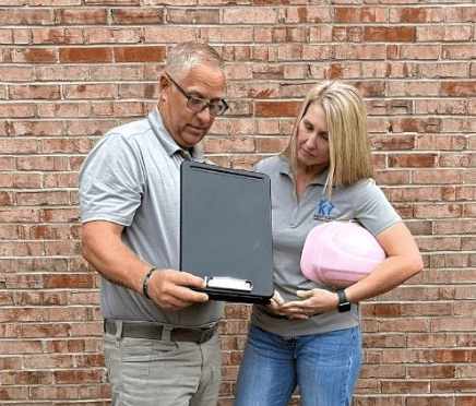 Chris-and-lisa-robinson-owners-of-kentucky-inspection-service-company-with-hard-hats-and-looking-in-an-inspection-clip-board